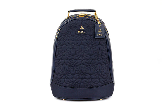 A blue quilted vegan Mae Medical Bag in Indigo with a gold handle by IYASU.