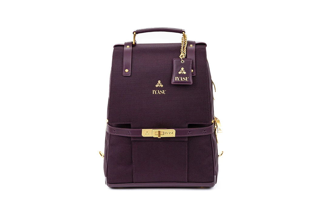 The Patricia Medical Bag In Mulberry by IYASU, a eco-friendly backpack with gold hardware, is perfect for everyday use.