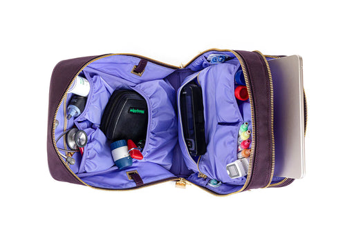 A purple IYASU Patricia Medical Bag in Mulberry with a laptop, cell phone, and other items inside.