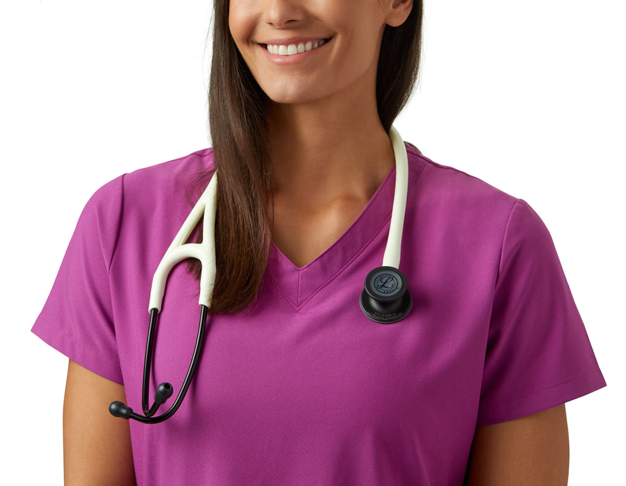 A smiling woman in a pink scrubs top with a 3M™ Littmann® Cardiology IV Diagnostic Stethoscope: Satin Alabaster Tube 6186C around her neck, cropped image showing only her torso and below the chin.