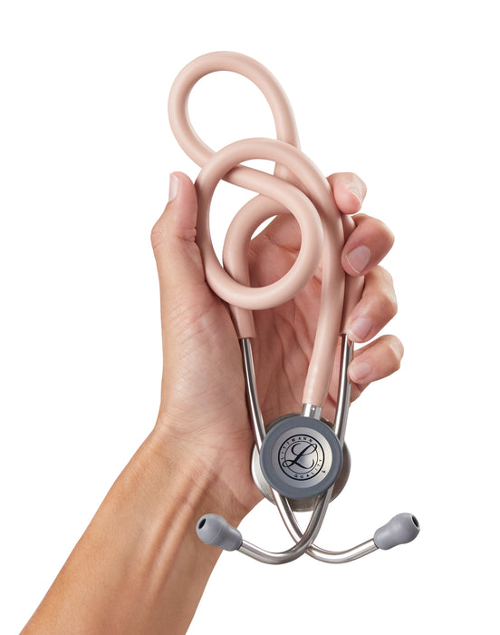 A hand holding a pink 3M™ Littmann® Classic III Monitoring Stethoscope: Satin Champagne Rose Tube 5910C against a white background.