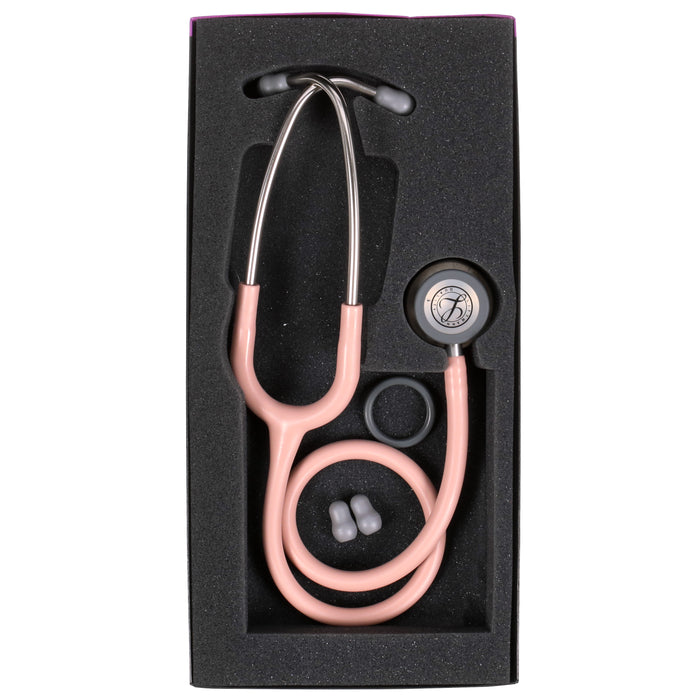 A pink 3M™ Littmann® Classic III Monitoring Stethoscope Satin Champagne Rose Tube 5910C with ear tips and a chest piece, presented in a black foam case.